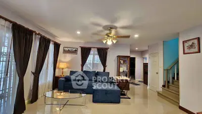 Spacious living room with elegant decor and cozy seating in a modern home.