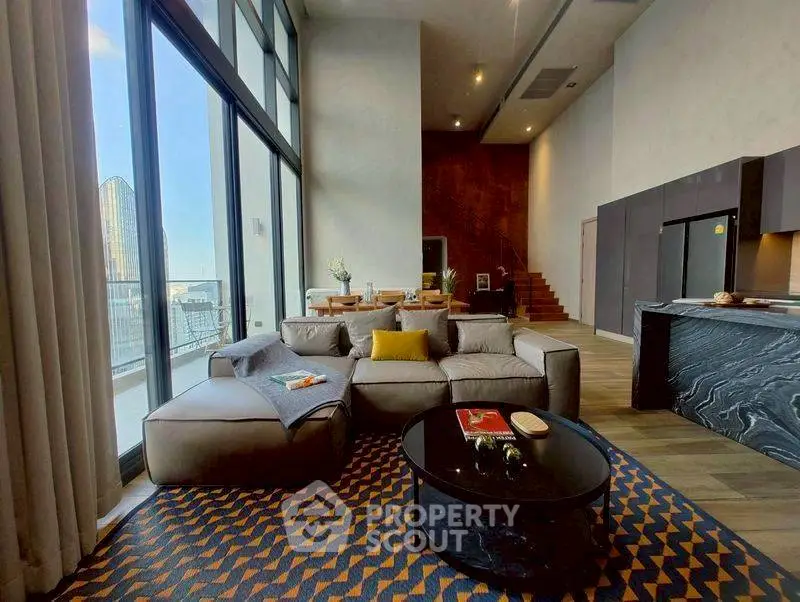 Luxurious modern living room with high ceilings and stunning city view.