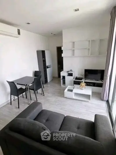 Modern living room with sleek furniture and natural light, perfect for urban living.