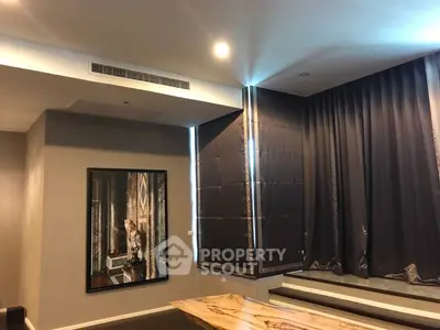 Elegant living room with modern decor and large window drapes