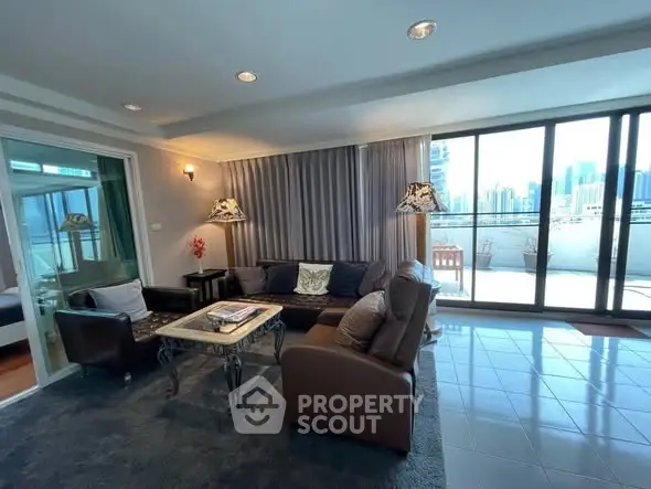 Spacious living room with large balcony and city view, perfect for urban living.