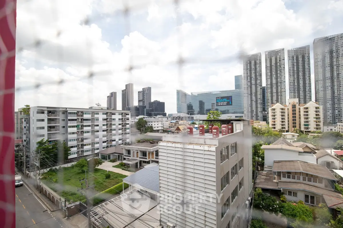 Stunning urban skyline view from a high-rise apartment, showcasing modern skyscrapers and residential buildings.
