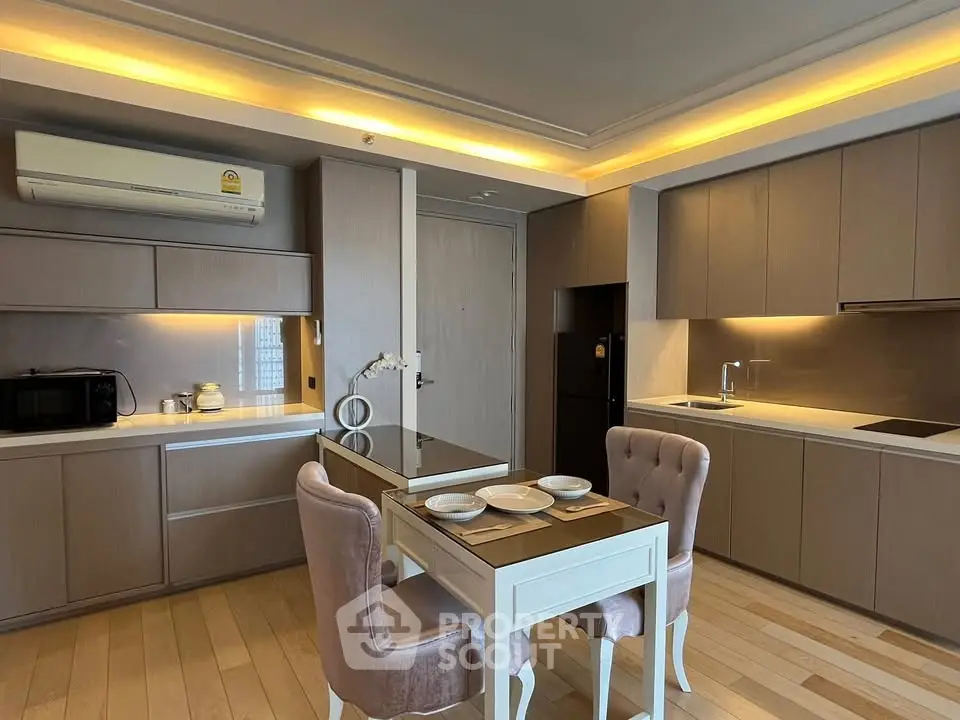 Modern kitchen with sleek cabinetry and cozy dining area in stylish apartment