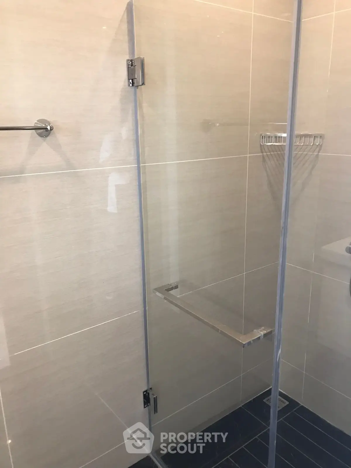 Modern bathroom with glass shower enclosure and sleek tile design