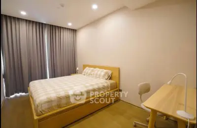 Modern bedroom with cozy bed and study desk, perfect for relaxation and productivity.