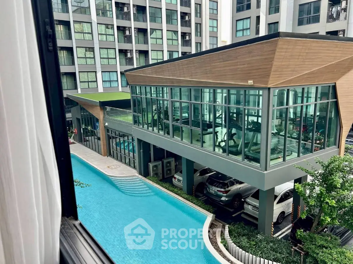 Modern apartment complex with pool and gym facilities, offering luxury living and convenience.