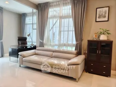 Elegant living room with modern leather sofa and stylish office corner