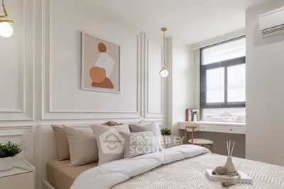 Elegant bedroom with modern decor and large window offering natural light.