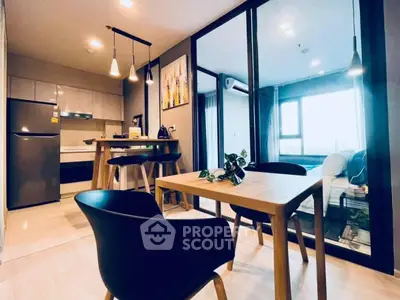 Modern open-plan kitchen and dining area with stylish furniture and natural light.