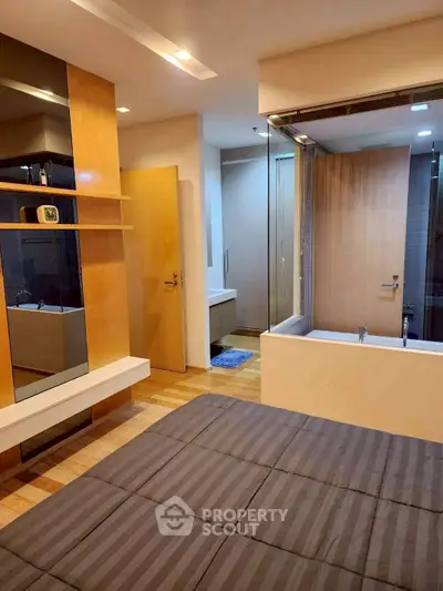 Modern bedroom with ensuite bathroom featuring wooden accents and sleek design.