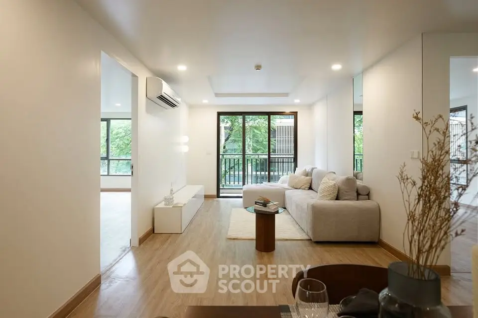 Spacious modern living room with large windows and cozy seating area