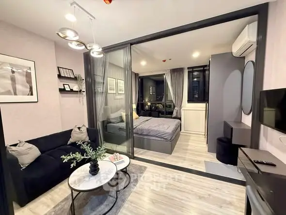 Modern studio apartment with stylish living area and cozy bedroom