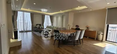 Spacious modern living and dining area with elegant decor and natural light.