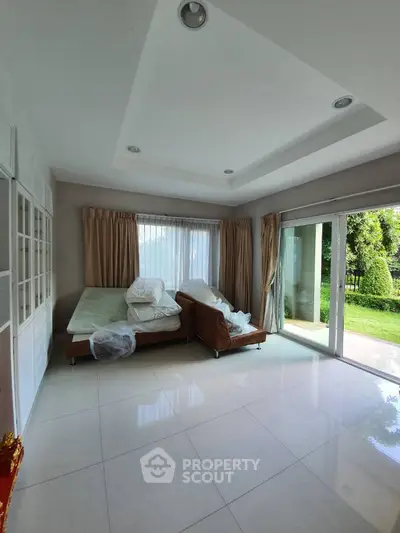 Spacious living room with large windows and garden view