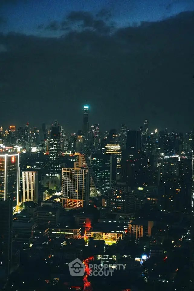 Stunning city skyline view at night with illuminated skyscrapers and vibrant city lights.