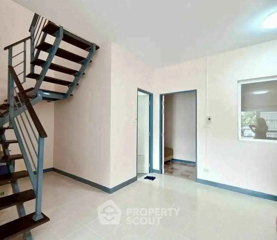 Modern duplex interior with sleek staircase and bright open space