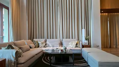 Luxurious living room with elegant decor and floor-to-ceiling curtains in a modern apartment.