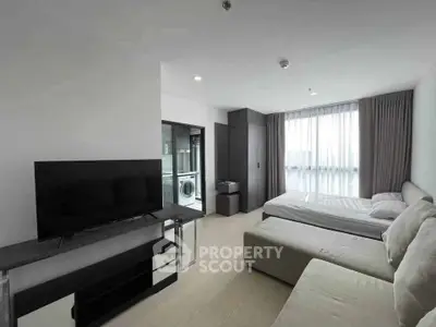 Modern studio apartment with sleek furnishings and natural light