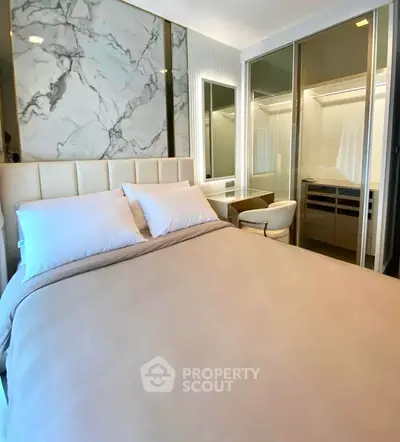 Luxurious bedroom with marble accent wall and modern furnishings