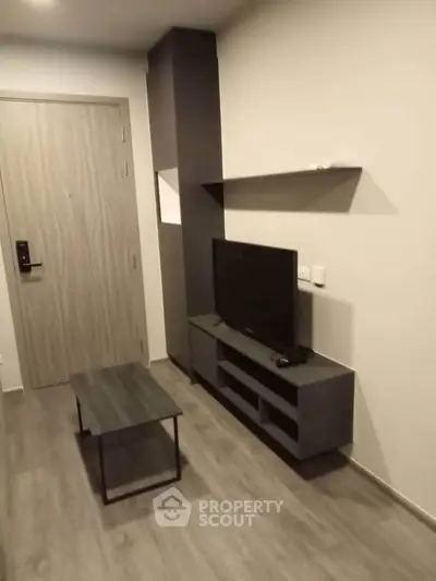 Modern living room with sleek TV stand and coffee table, perfect for cozy entertainment.