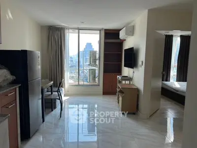 Modern apartment with open layout, city view, and sleek furnishings.
