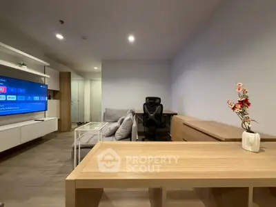 Modern living room with sleek furniture and smart TV, perfect for relaxation and entertainment.