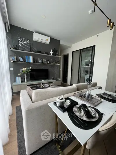 Modern living room with elegant decor and open layout, featuring a cozy dining area and stylish furnishings.