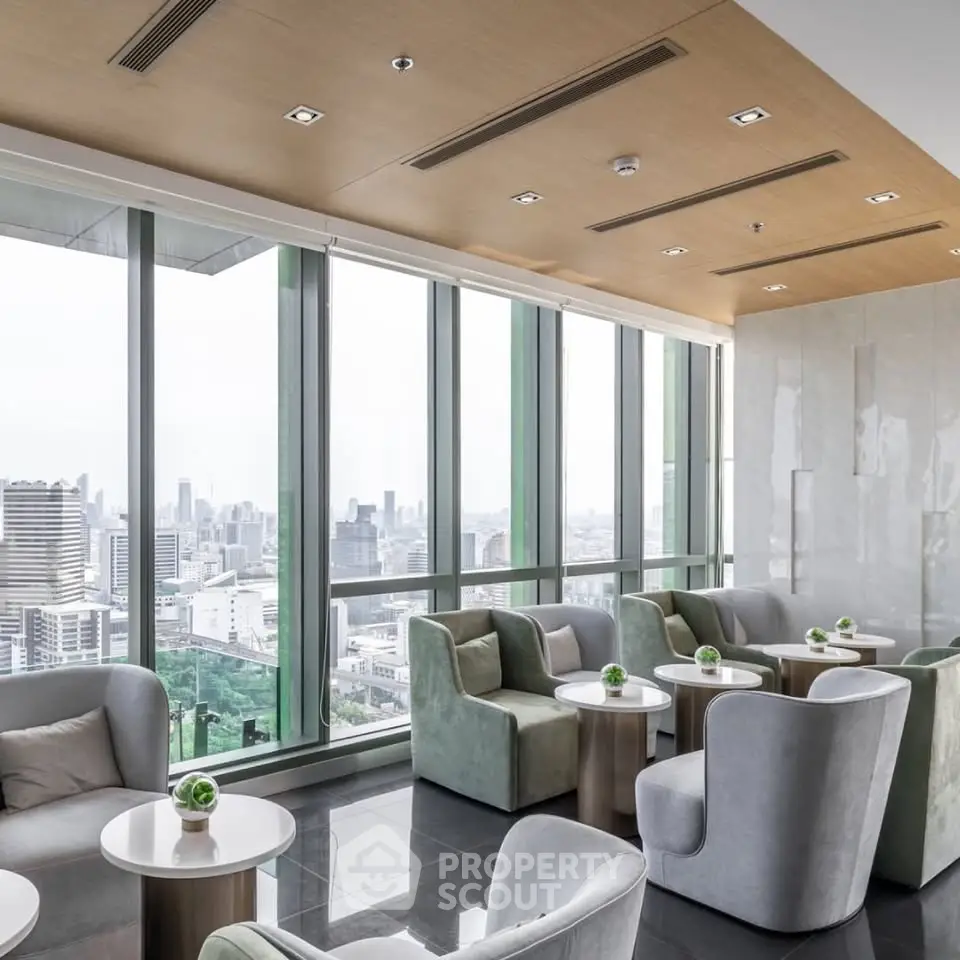Luxurious high-rise building lounge with panoramic city views and modern seating.