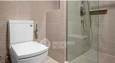 Modern bathroom with sleek shower and contemporary toilet design.