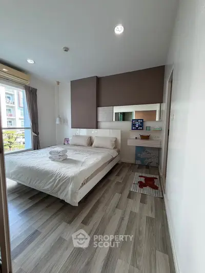 Modern bedroom with stylish decor and ample natural light