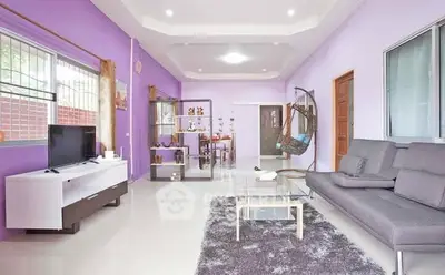 Spacious modern living room with purple walls and stylish decor