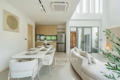 Modern open-plan living and dining area with sleek kitchen and stylish decor.