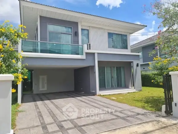 Modern two-story house with spacious driveway and lush garden