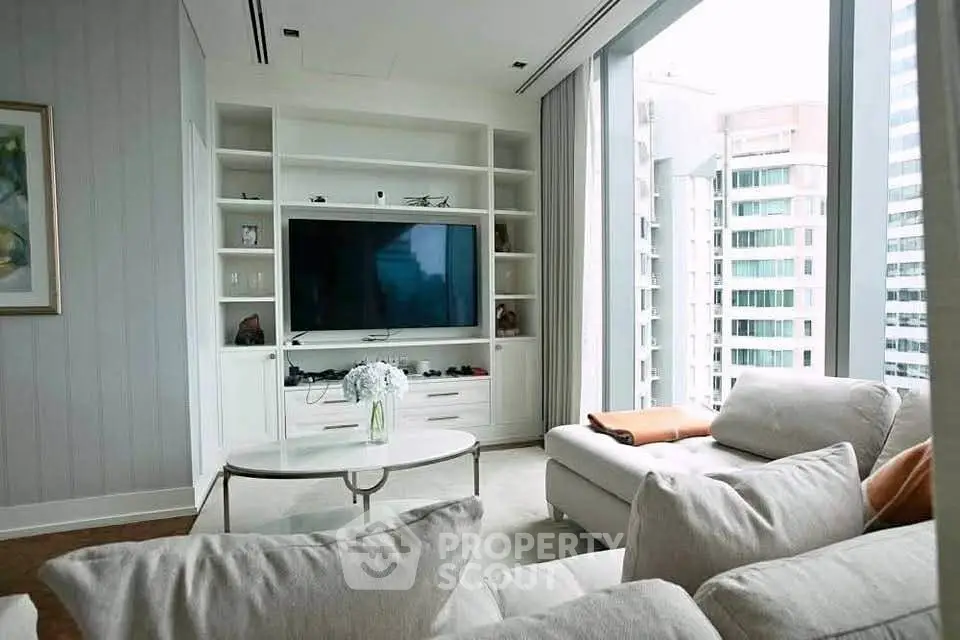 Luxurious living room with modern entertainment center and city view, perfect for urban living.