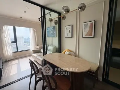Modern dining area with stylish decor and city view in a high-rise apartment