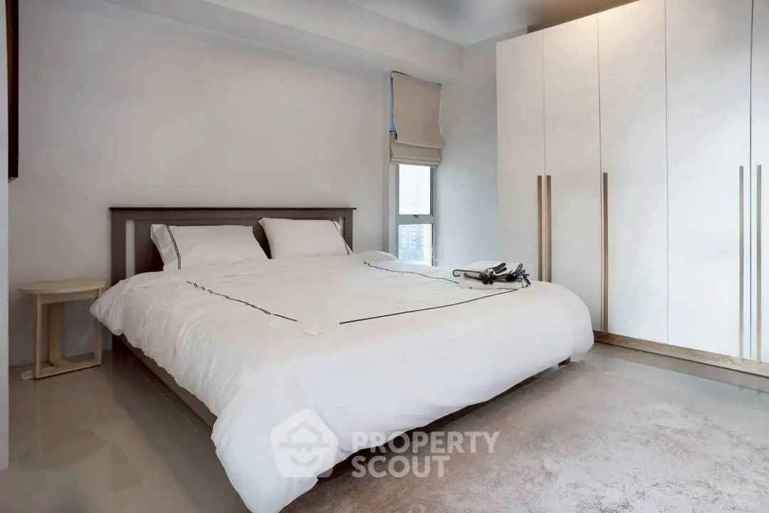 Modern minimalist bedroom with sleek wardrobe and cozy bed