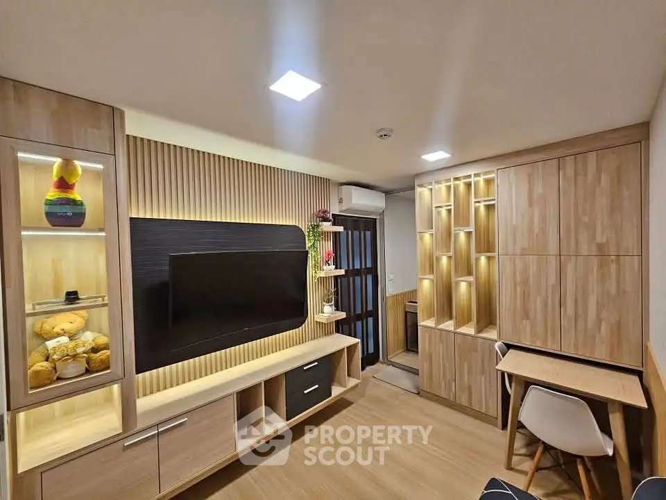 Modern living room with stylish wooden furniture and built-in storage solutions.