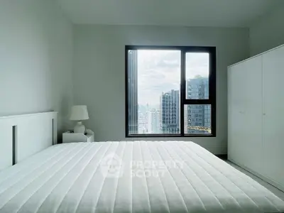 Modern bedroom with city view, featuring a large window and minimalist decor.