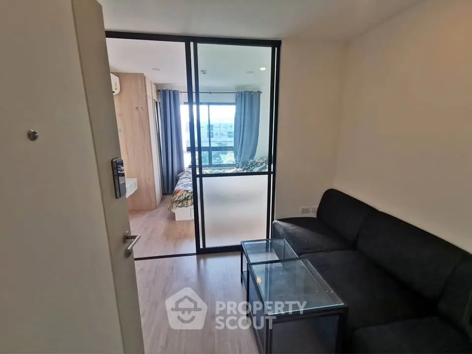 Modern apartment interior with glass partition and cozy living area