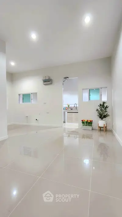 Spacious modern interior with glossy tiled floors and minimalist decor