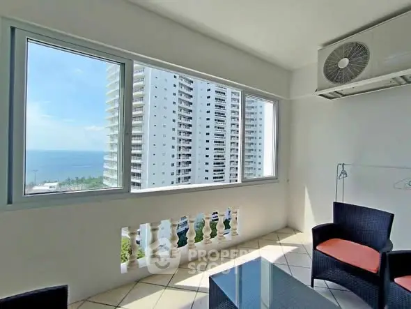 Spacious balcony with ocean view in modern high-rise apartment