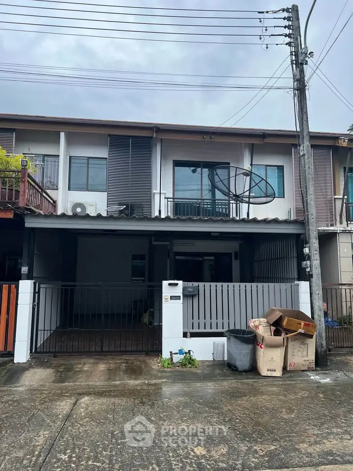 Charming two-story townhouse with gated entrance and modern facade