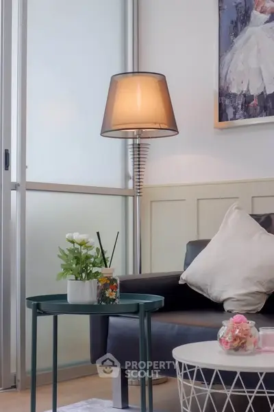 Chic living room with modern decor, featuring stylish furniture and elegant lighting.