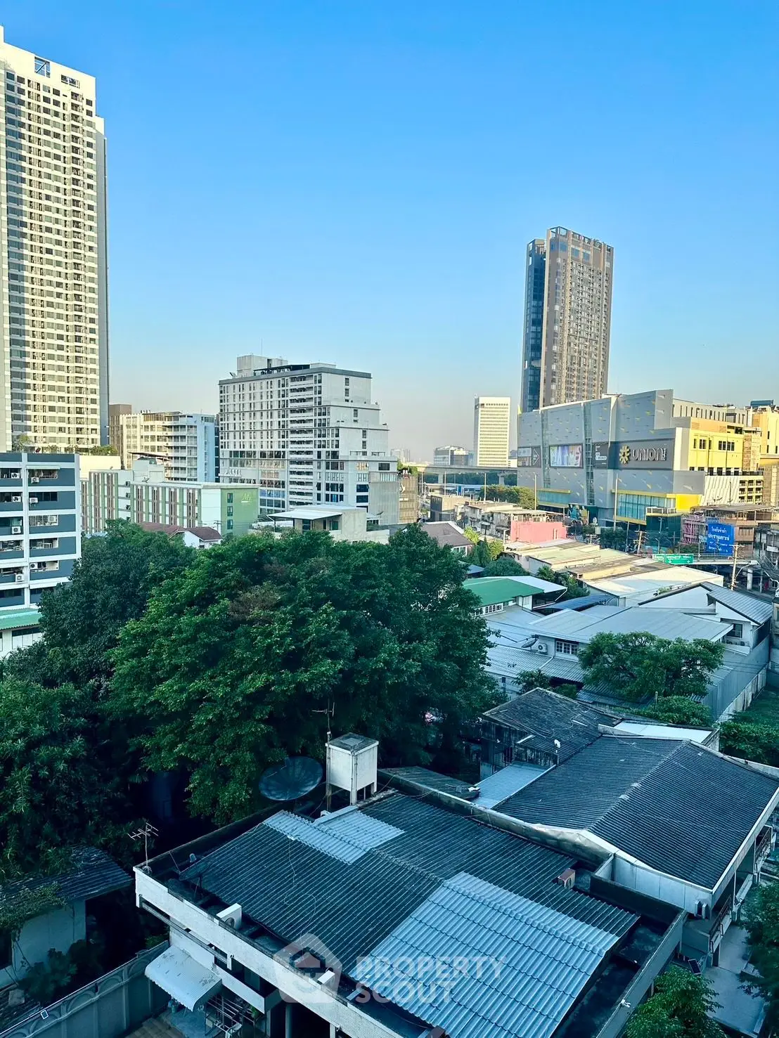 Stunning cityscape view showcasing modern high-rise buildings and lush greenery, perfect for urban living.