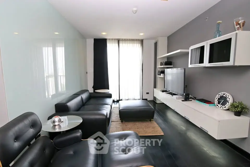 Modern living room with sleek black furniture and stylish decor