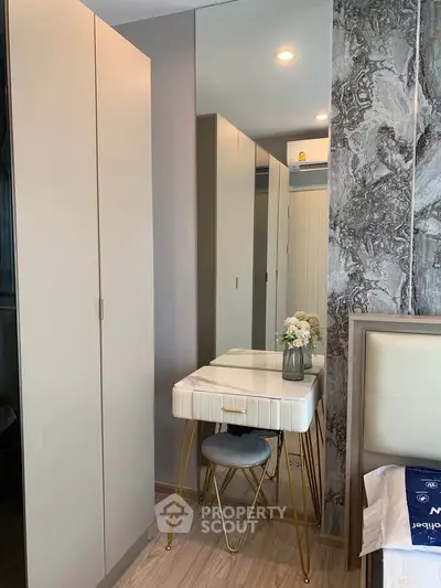 Modern bedroom with stylish vanity and ample storage space