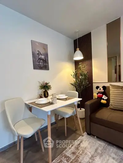 Cozy living room with dining area, modern decor, and plush seating in a stylish apartment.