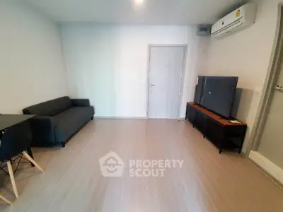 Modern living room with sleek furniture and air conditioning, perfect for comfortable living.