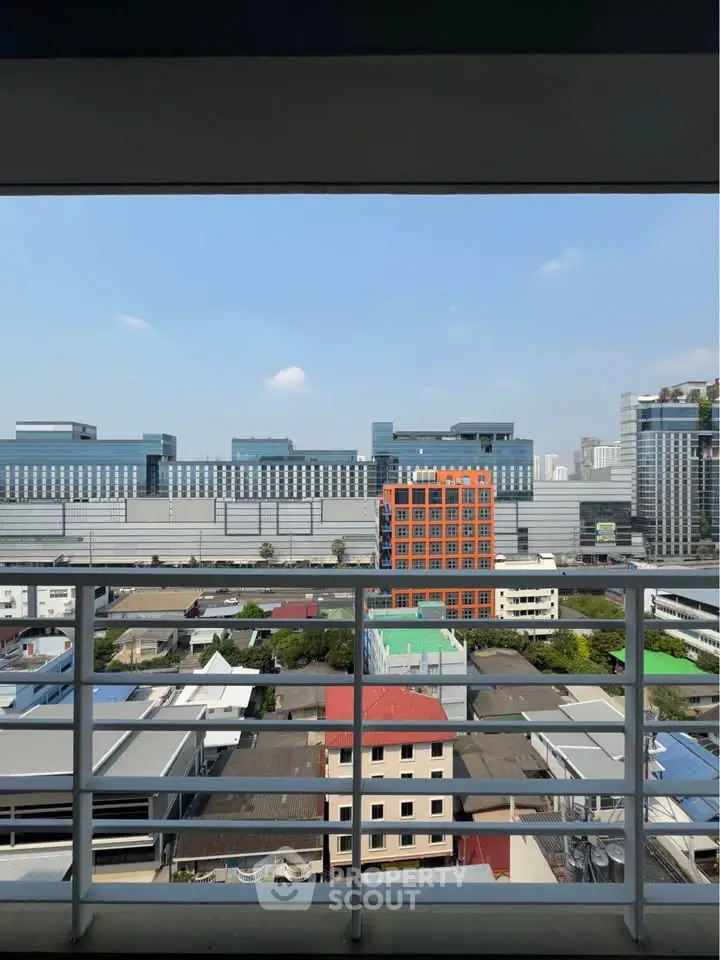 Stunning urban view from a high-rise balcony overlooking cityscape and modern architecture.
