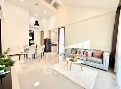 Bright and spacious living room with modern decor and dining area